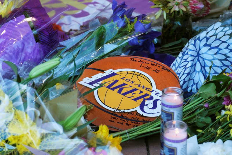 Flowers, photos and messages are placed at a makeshift memorial for former NBA player Kobe Bryant outside of the Mamba Sports Academy in Thousand Oaks