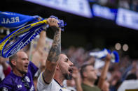 Real Madrid's supporters cheer their team during the the Spanish La Liga soccer match between Real Madrid and Cadiz at the Santiago Bernabeu stadium in Madrid, Spain, Saturday, May 4, 2024. (AP Photo/Manu Fernandez)