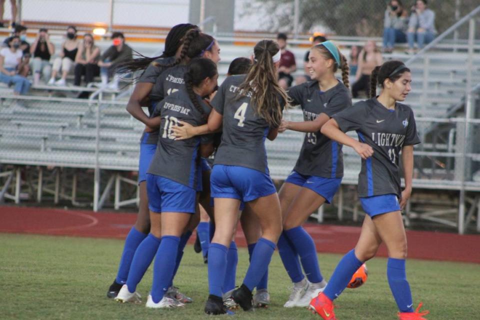 Cypress Bay players mob Natalia Ballinas following her first half goal that gave the Lightning a 1-0 lead in Friday night’s Class 7A state semifinal at Cypress Bay High School