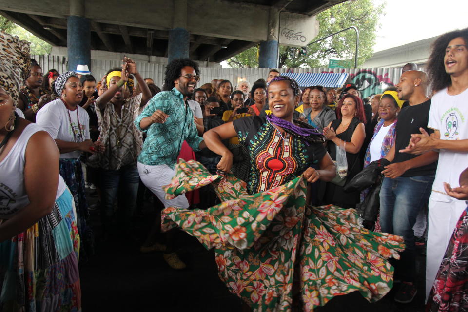 Brazilians dance in the "roda do Jongo" in Madureira under a bridge.