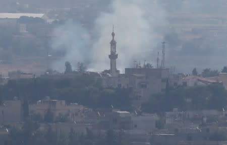 Smoke rises over the Syrian town of Ras al-Ain as seen from the Turkish border town of Ceylanpinar