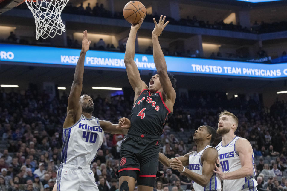 Toronto Raptors forward Scottie Barnes (4) shoots over Sacramento Kings forward Harrison Barnes (40) during the first quarter of an NBA basketball game in Sacramento, Calif., Wednesday, Jan. 25, 2023. (AP Photo/Randall Benton)