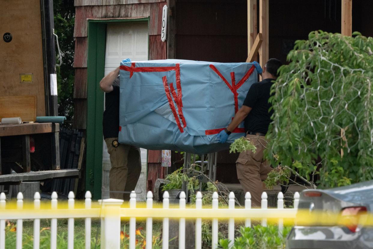 New York State police officers carry out a large item as law enforcement searches the home of Rex Heuermann, Saturday, July 15, 2023, in Massapequa Park, N.Y. (AP)