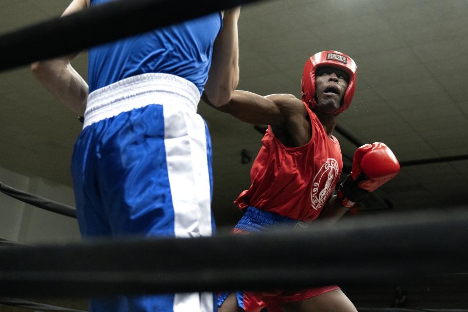 Theon Davis, 21, right, fights Eduardo Camacho in the 176-pound championship bout on the final night of the 100th year of the Chicago Golden Gloves boxing tournament Sunday, April 16, 2023, in Cicero, Ill. Davis won by split decision. (AP Photo/Erin Hooley)