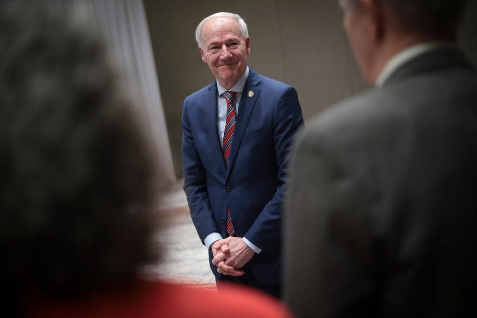 Former Arkansas Gov. Asa Hutchinson greets attendees at the Vision ’24 National Conservative Forum March 18, 2023 in Charleston, South Carolina.