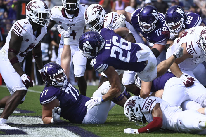 Northwestern running back Evan Hull (26) scores a touchdown against Southern Illinois during the first half of an NCAA college football game Saturday, Sept. 17, 2022, in Evanston, Ill. (AP Photo/Matt Marton