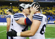 Toronto Argonauts Adriano Belli (L) kisses Jeff Keeping after they defeated the Montreal Alouettes in the CFL's Eastern Conference Final football game in Montreal, November 18, 2012. REUTERS/Christinne Muschi (CANADA - Tags: SPORT FOOTBALL TPX IMAGES OF THE DAY) 