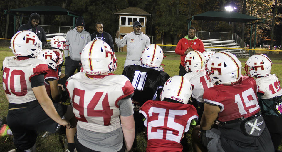 This photo provided by the University of Maryland shows Terrence Byrd, president of Maryland Heat, a youth tackle football program, speaking to players after practice in Fort Washington, Md., Nov. 9, 2023. Tackle football offers children as young as 5 the chance to make friends, learn teamwork and maybe win a college scholarship. Growing research shows it also can cause injuries that damage developing brains. (University of Maryland/Torrence Banks via AP)