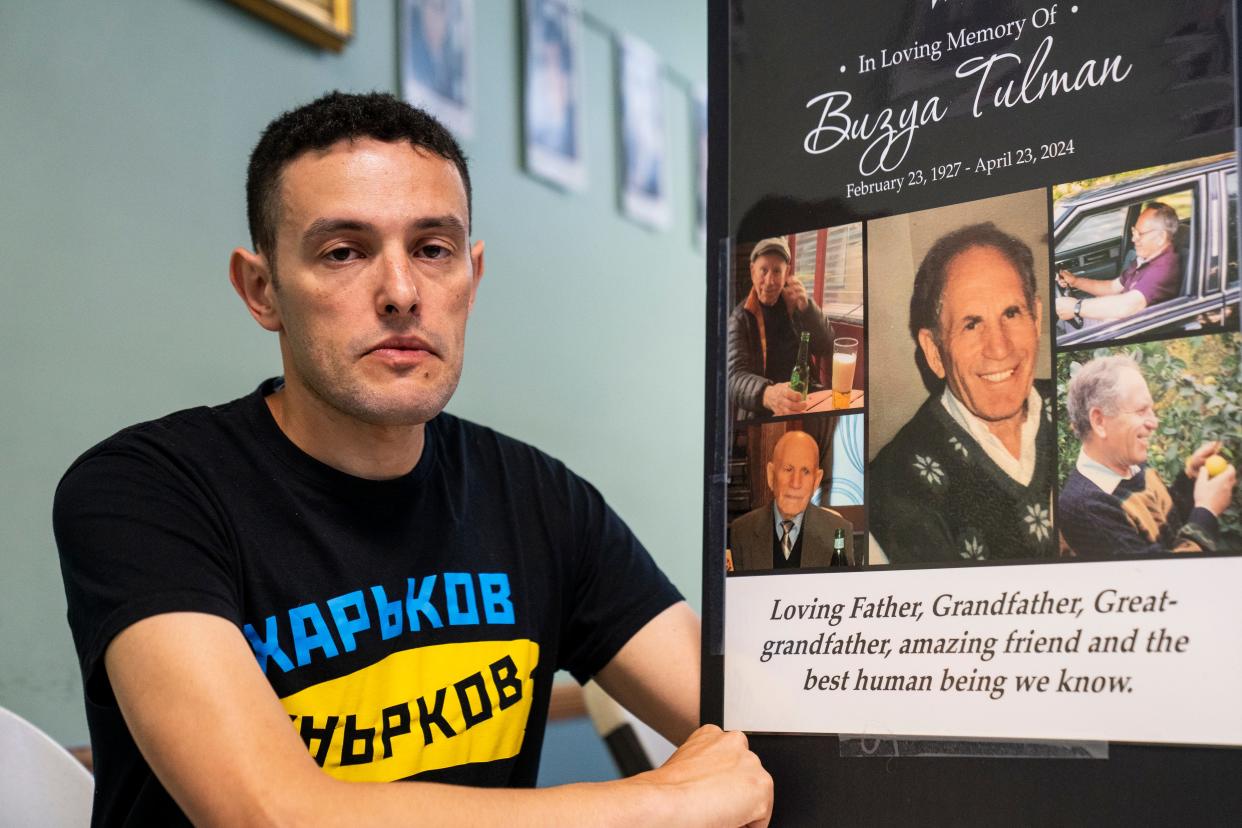 May 8, 2024; Teaneck, N.J.; Slava Koza holds a poster with photos of his grandfather, Boris Tulman, who survived the Nazi invasion of Russia during the Holocaust with the help of a woman named Maria Petrovna Svyatoshova.