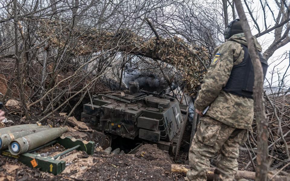 Ukrainian soldiers fire artillery at their fighting position in the direction of Bakhmut