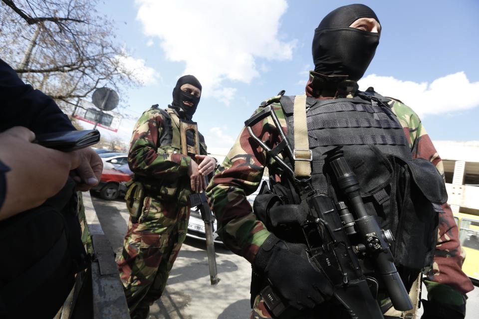 Russian soldiers guard the center of Simferopol, Crimea, Thursday, March 27, 2014. Crimea's government has decided to disband self-defense forces which provided help to the Russian military which have been occupying since late February. (AP Photo/Max Vetrov)