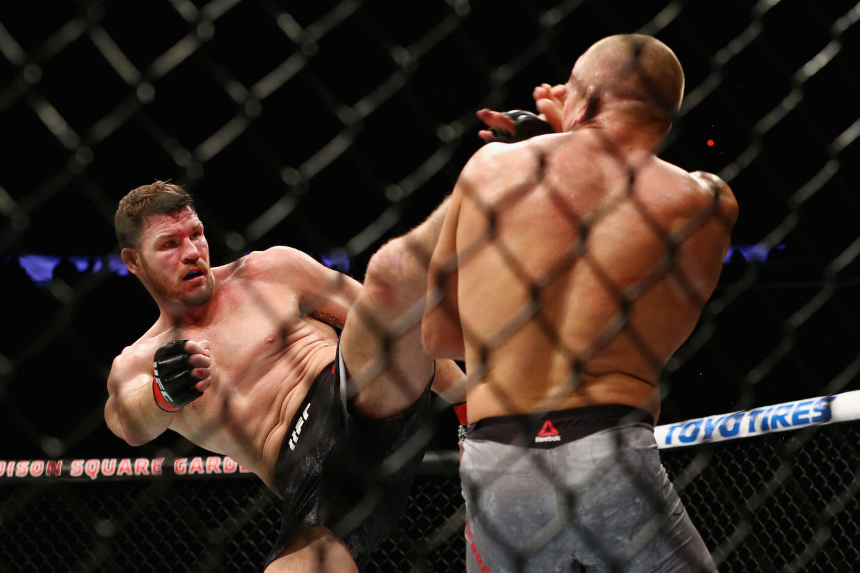 Michael Bisping, shown kicking Georges St-Pierre on Nov. 4 in their middleweight title fight in New York, returns to action Saturday against Kelvin Gastelum in a bout streamed on UFC Fight Pass. (Getty Images)