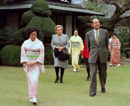 FILE PHOTO: File photo of French President Jacques Chirac and his wife Bernadette led by kimono-clad hostesses arriving at Japanese-style restaurant Hannyaen in Tokyo