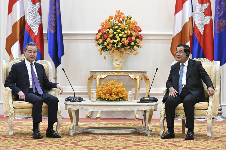 In this photo provided by Kok Ky/Cambodia's Government Cabinet, Cambodian Prime Minister Hun Sen, right, talks with Chinese Foreign Minister Wang Yi during a meeting in Peace Palace in Phnom Penh, Cambodia, Sunday, Aug. 13, 2023. (Kok Ky/Cambodia's Government Cabinet via AP)