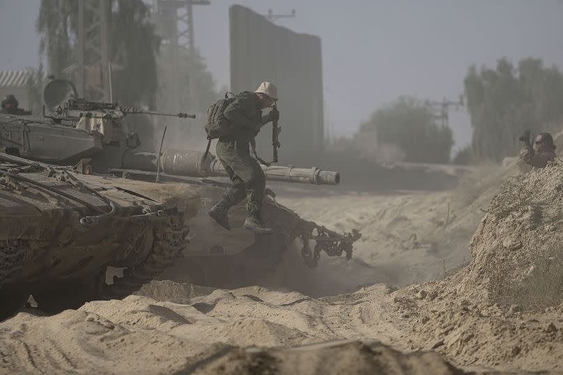 An Israeli soldier dismounts from his tank near the Israel-Gaza border, July 12, 2024