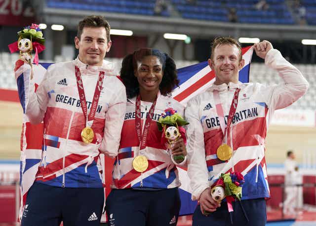 Kadeena Cox, centre, celebrates gold alongside Jaco van Gass, left, and Jody Cundy, right, in Tokyo 