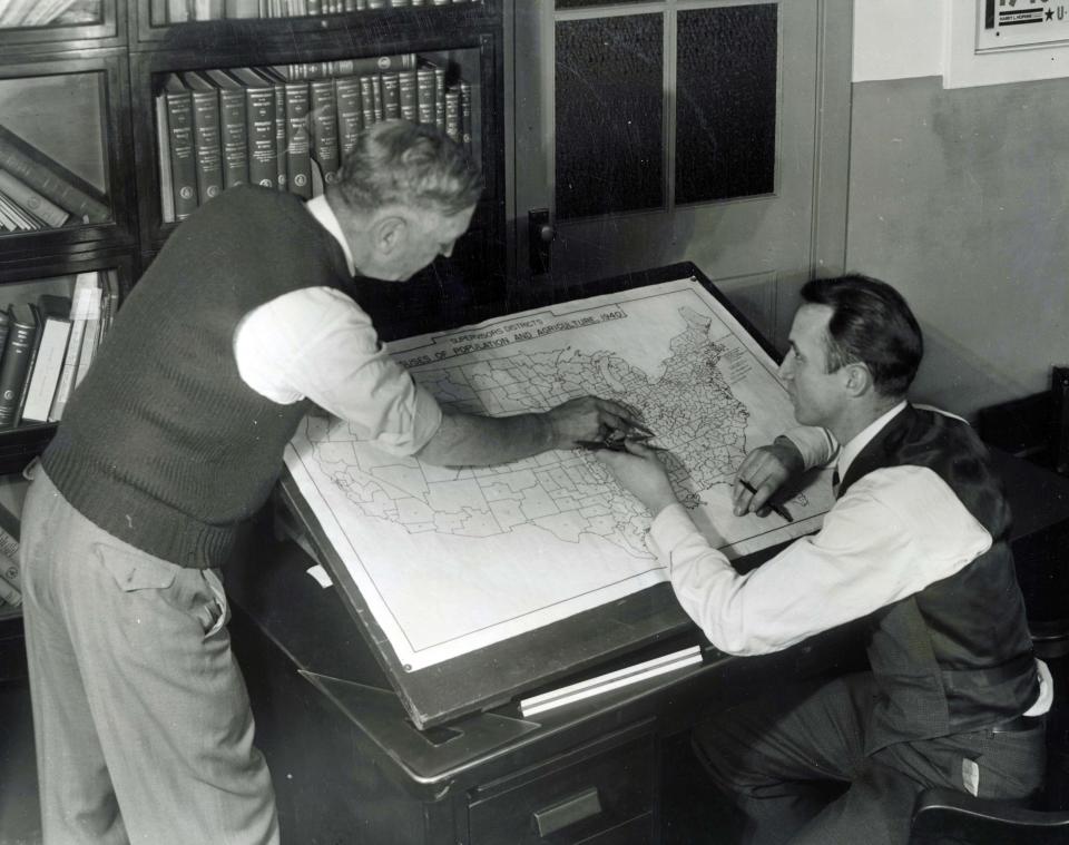 In this undated photo provided by the Franklin D. Roosevelt Presidential Library and Museum, staffers at the U.S. Census Bureau in Washington mark up a map for use in the 1940 census. The map shows approximately 147,000 enumeration districts for census-taking purposes and will ensure against overlapping activities of census takers, or enumerators, and also to avoid missing any territory. (AP Photo/Franklin D. Roosevelt Presidential Library)