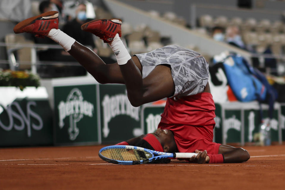 Sweden's Mikael Ymer slips and falls in the first round match of the French Open tennis tournament against Serbia's Novak Djokovic at the Roland Garros stadium in Paris, France, Tuesday, Sept. 29, 2020. (AP Photo/Alessandra Tarantino)