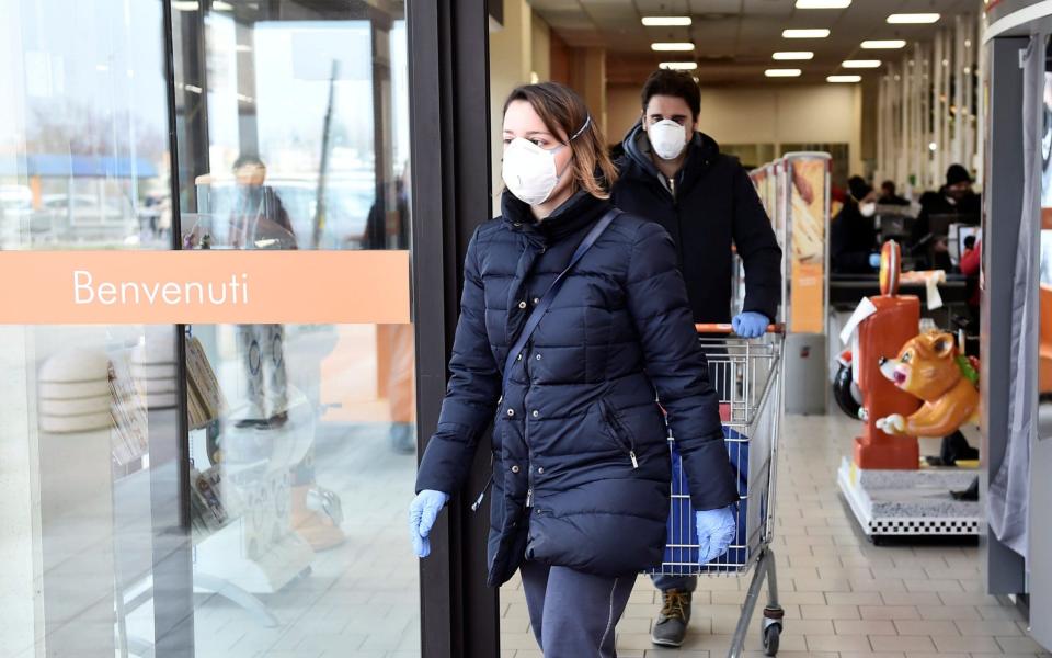 People wearing face masks leave a supermarket in the town of Casalpusterlengo, which has been closed by the Italian government due to a coronavirus outbreak in northern Italy, - reuters 