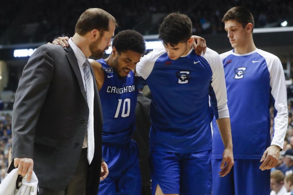 Creighton's Maurice Watson Jr. (10) is helped off the court with an injury in the first half of an NCAA college basketball game, Monday, Jan. 16, 2017, in Cincinnati. Watson Jr. was later carried off the court after reentering the game and being injured again. (AP Photo/John Minchillo)