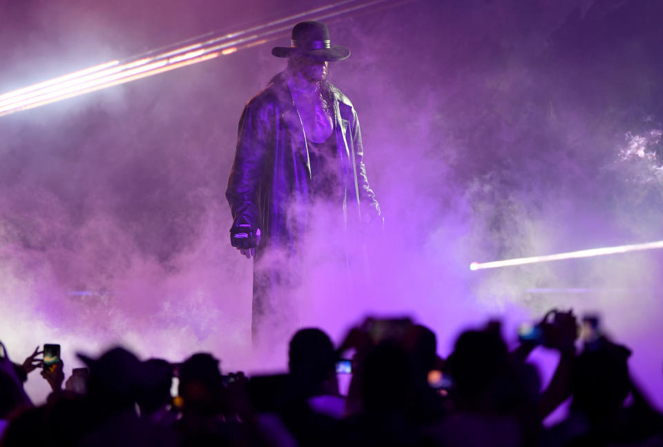 TOPSHOT - World Wrestling Entertainment star The Undertaker makes his way to the ring during a match at the World Wrestling Entertainment (WWE) Super Showdown event in the Saudi Red Sea port city of Jeddah late on January 7, 2019. (Photo by Amer HILABI / AFP)        (Photo credit should read AMER HILABI/AFP via Getty Images)