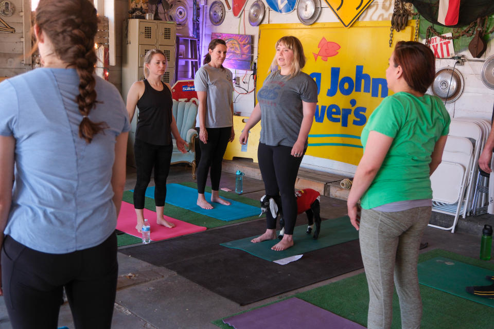 Yoga instructor Megan Stuntz gets assistance from a young goat last weekend at The Garage event venue on the Historic Route 66 in Amarillo.