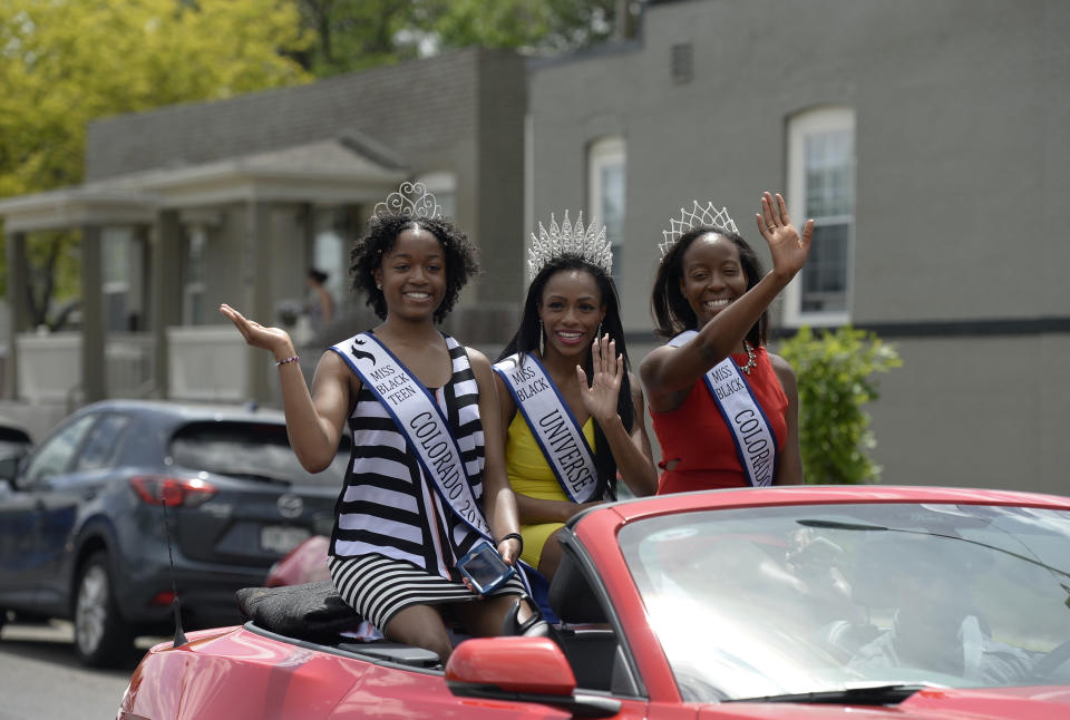 DENVER, CO - JUNE 17: Miss Teen Black Colorado Genesis Oats, 17, left, Miss Black Universe 2017, Michaela Jones, 28, and Miss Black Colorado Universe Lesley Pace, 25, right, join participants in the Juneteenth Music Festival and parade as they make their way down E. 26th Ave. on June 17, 2017 in Denver, Colorado. Organizers say its one of Denver's longest running parades dating back to the 1950's where "nearly 3,000 people march to honor the struggles and social progress achieved through marches and demonstrations organized for freedom, justice, and equality in our countrys history". This year's theme for the event is Dream Big. (Photo by Kathryn Scott/The Denver Post via Getty Images)