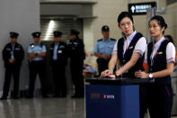 Staff and police stand next to a counter at West Kowloon terminus, during the opening ceremony of the Hong Kong Section of the Guangzhou-Shenzhen-Hong Kong Express Rail Link, in Hong Kong, China September 22, 2018. REUTERS/Tyrone Siu