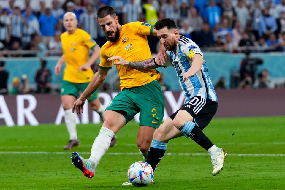 Crew defender Milos Degenek, here playing for Australia, battles Argentina's Lionel Messi in a World Cup game on Dec. 3.