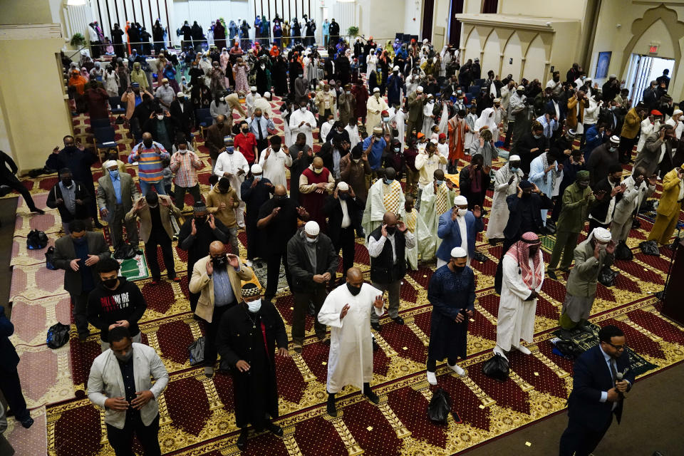 Worshippers perform an Eid al-Fitr prayer at the Masjidullah Mosque in Philadelphia, Thursday, May 13, 2021. Millions of Muslims across the world are marking the holiday of Eid al-Fitr, the end of the fasting month of Ramadan. (AP Photo/Matt Rourke)