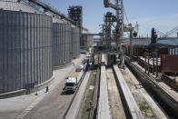 Trucks loaded with grain wait in line at the Comvex handling and storage facility in the Black Sea port of Constanta, Romania, Tuesday, June 21, 2022. While Romania has vocally embraced the ambitious goal of turning into a main hub for the export of agricultural products from Ukraine, economic experts and port operators in the country warn that it was much easier objective to set than to actually achieve. (AP Photo/Vadim Ghirda)