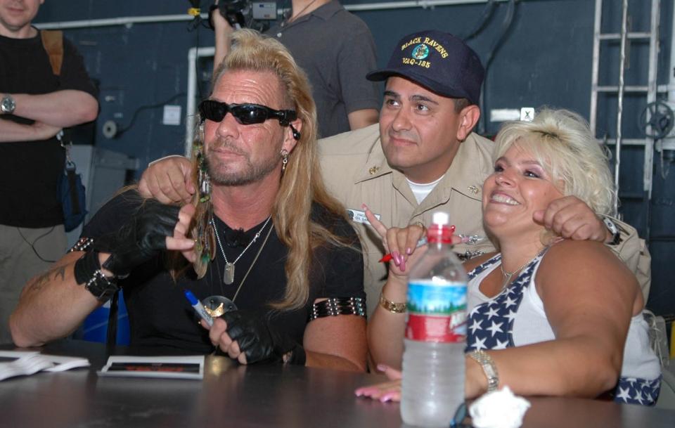Duane Chapman in a group photo with his late wife, Beth Smith and another man, and they are smiling beautifully.