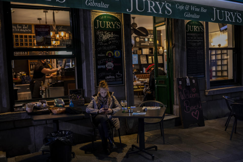 A woman sits outside a bar, in Gibraltar, Thursday, March 4, 2021. Gibraltar, a densely populated narrow peninsula at the mouth of the Mediterranean Sea, is emerging from a two-month lockdown with the help of a successful vaccination rollout. The British overseas territory is currently on track to complete by the end of March the vaccination of both its residents over age 16 and its vast imported workforce. But the recent easing of restrictions, in what authorities have christened “Operation Freedom,” leaves Gibraltar with the challenge of reopening to a globalized world with unequal access to coronavirus jabs. (AP Photo/Bernat Armangue)