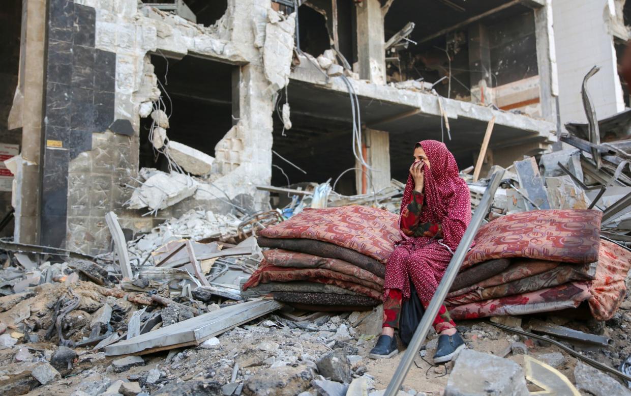 A Palestinian woman sits amidst the rubble of Al-Shifa after the IDF withdrawal