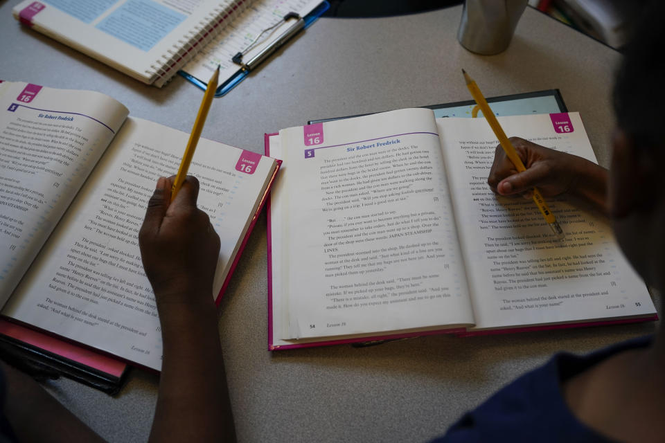 Third graders read during class at Schaumburg Elementary, part of the ReNEW charter network, in New Orleans, Wednesday, April 19, 2023. (AP Photo/Gerald Herbert)