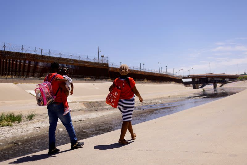 FILE PHOTO: Asylum-seeking migrants cross the Rio Bravo river in El Paso