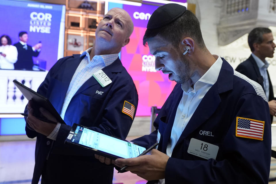 Traders Patrick Casey, left, and Orel Parish work on the floor of the New York Stock Exchange, Wednesday, Aug. 30, 2023. Stocks are edging mostly higher in early trading on Wall Street chipping a bit more away from the market's losses in August. (AP Photo/Richard Drew)