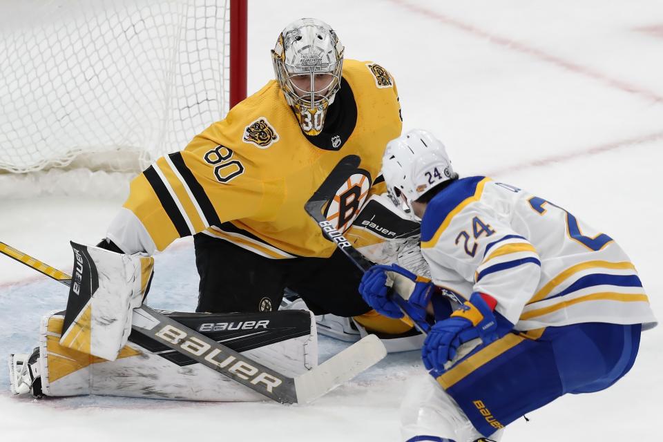 Boston Bruins' Dan Vladar (80) defends against Buffalo Sabres' Dylan Cozens (24) during the first period of an NHL hockey game, Saturday, March 27, 2021, in Boston. (AP Photo/Michael Dwyer)