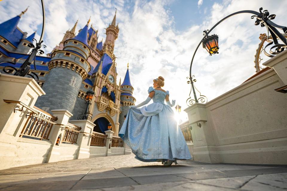 cinderella poses in front of cinderella castle inside magic kingdom park at walt disney world resort in lake buena vista, fla matt stroshane, photographer