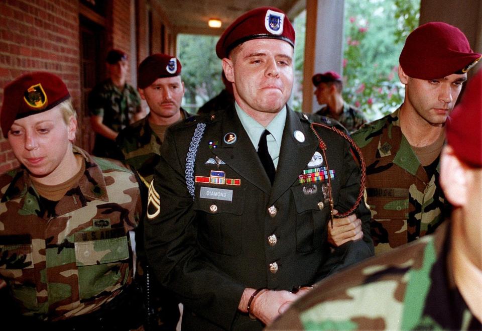 Staff Sgt. John Diamond is escorted from the Staff Judge Advocate Office, Monday evening Aug. 27, 2001, after he was found guilty on all counts in the death of Air Force Capt. Marty Theer.