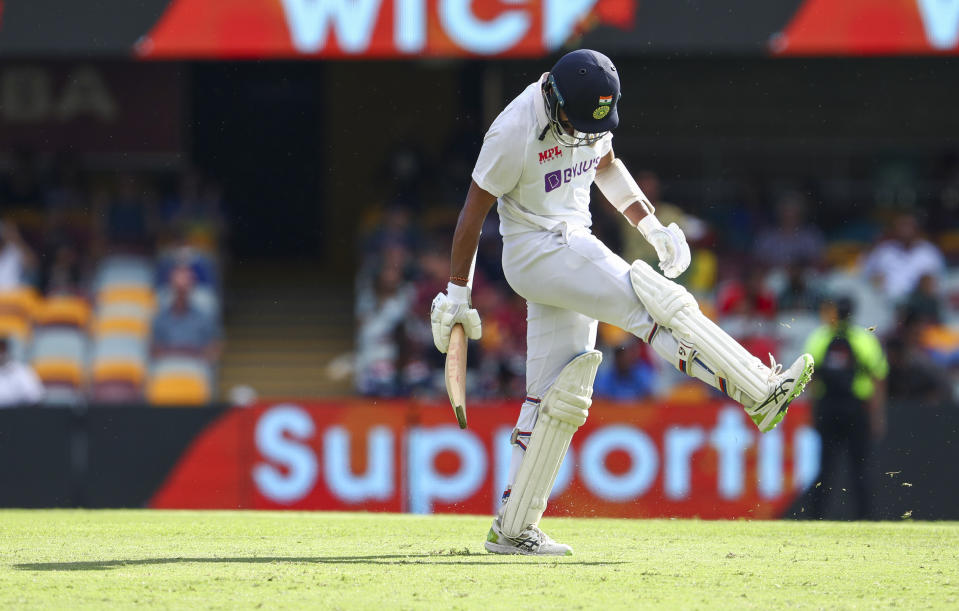 India's Cheteshwar Pujara reacts in frustration after he was dismissed during play on the final day of the fourth cricket test between India and Australia at the Gabba, Brisbane, Australia, Tuesday, Jan. 19, 2021. (AP Photo/Tertius Pickard)