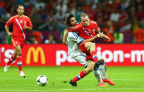 WARSAW, POLAND - JUNE 16: Aleksandr Anyukov of Russia and Giorgos Samaras of Greece battle for the ball during the UEFA EURO 2012 group A match between Greece and Russia at The National Stadium on June 16, 2012 in Warsaw, Poland. (Photo by Shaun Botterill/Getty Images)