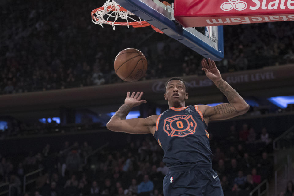 Knicks forward Troy Williams dunks during the second half on Sunday in a loss to the Raptors. (AP)