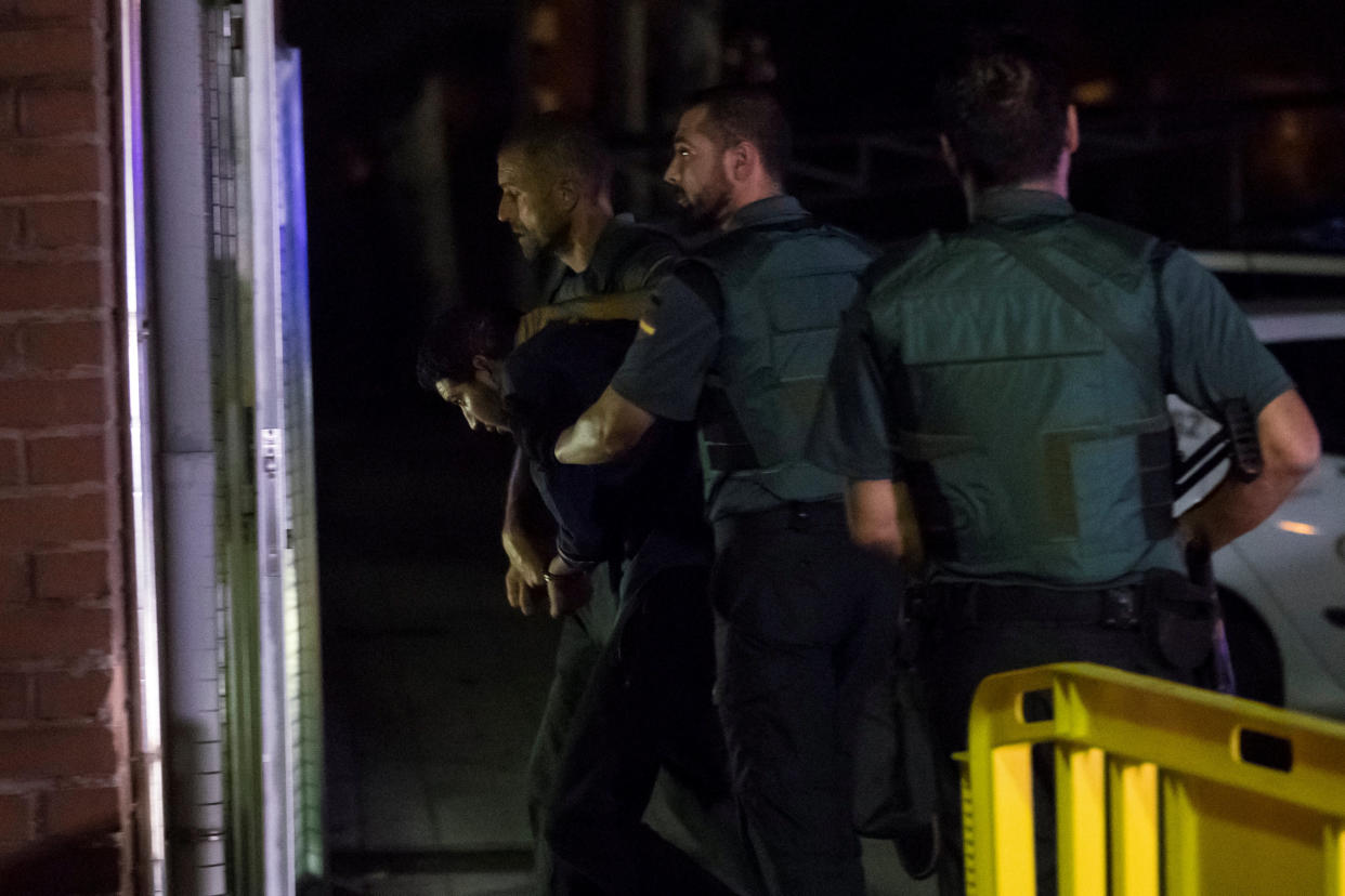 <em>Spanish Civil Guards escort one of four men accused of involvement in an Islamist cell behind the Barcelona terrorist attacks (Reuters)</em>