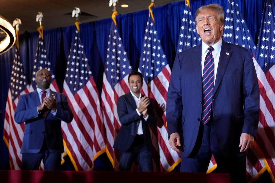 Republican presidential candidate former President Donald Trump arrives to speak at a primary election night party in Nashua, N.H., Tuesday, Jan. 23, 2024, as Sen. Tim Scott, R-S.C., and Vivek Ramaswamy watch.