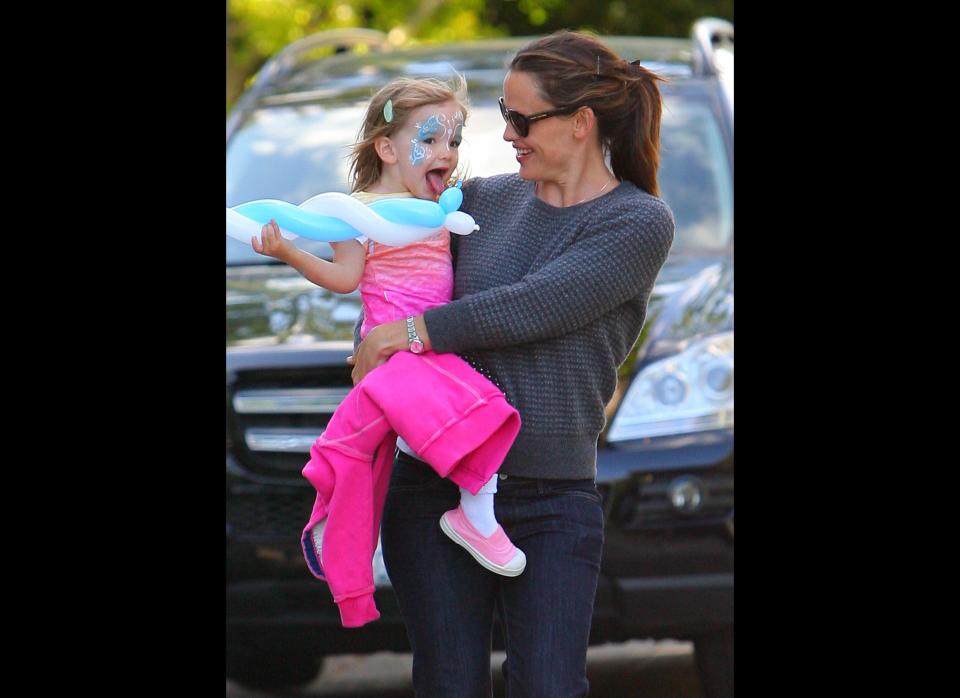 Jennifer Garner makes her way out of actor Adam Sandler'­s home with Seraphina, who holds on to a balloon and has a painted face.   
