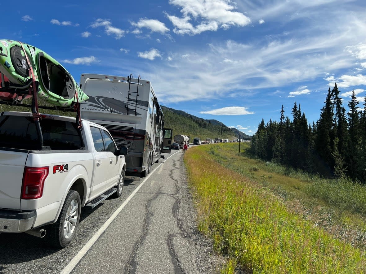 Traffic starts to pile up on the Alaska Highway after a semi-truck overturned on the highway and caught fire. Officials closed the section of the highway between the Carcross Cutoff to Jakes Corner until further notice on Thursday. (Kiyoshi McGuire/CBC - image credit)