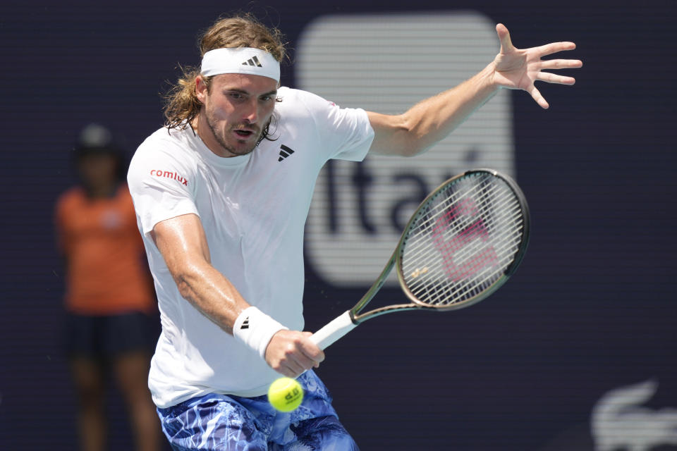 Stefanos Tsitsipas of Greece returns to Cristian Garin of Chile during the Miami Open tennis tournament, Monday, March 27, 2023, in Miami Gardens, Fla. (AP Photo/Marta Lavandier)