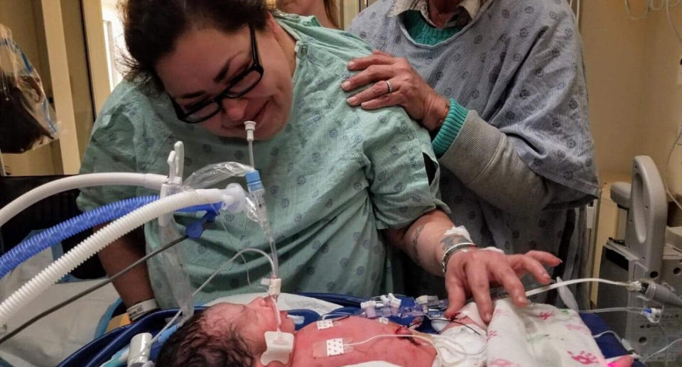 Alleged murderer, Clarisa Figueroa, stands over baby Yavani Yadiel Lopez in a Chicago hospital.