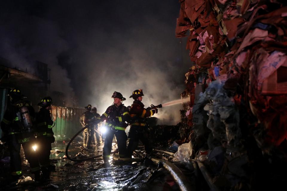 Firefighters water down a wall of cardboard at Recycle City Inc. in Clifton. The two alarm blaze started during the 7pm hour and took approximately four hours to be placed under control.  There were no injuries reported as a result of the fire. Tuesday, March 2, 2021